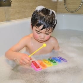Child playing with Bath Time Xylophone
