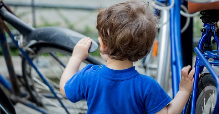 Toddler playing with bike