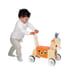 young child pushing a ride on donkey toy