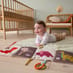 Child playing with Activity Book - Dino on the floor